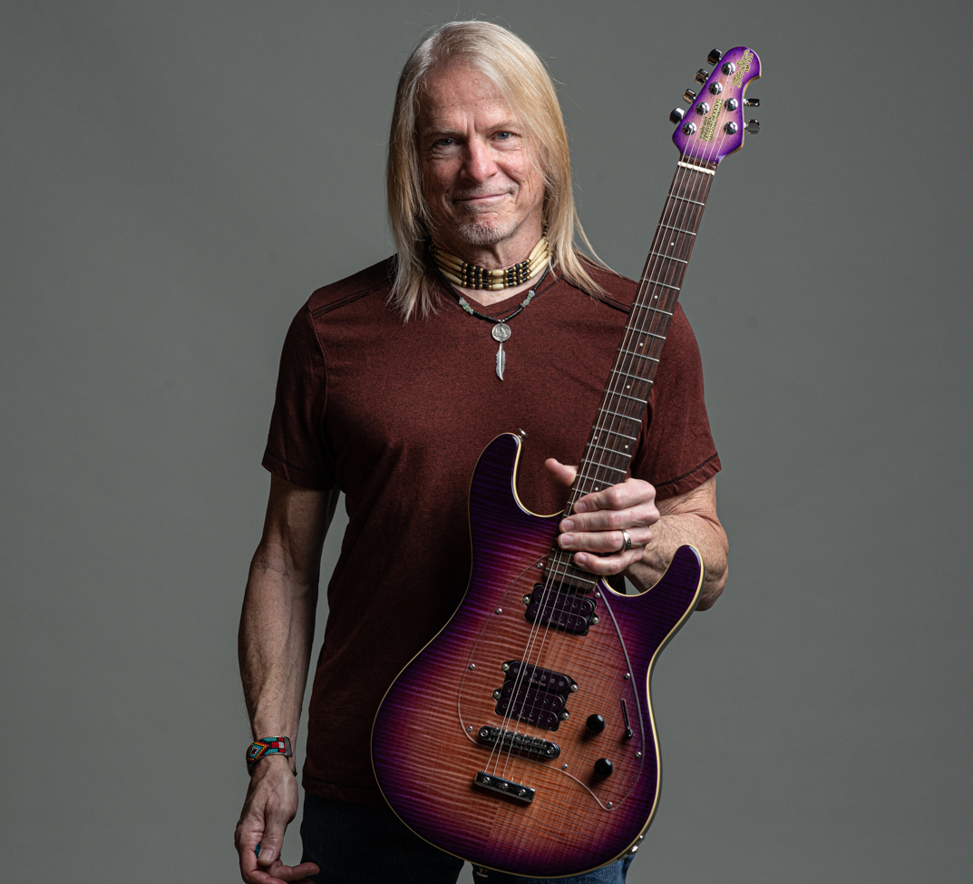 Steve Morse poses with his signature Ernie Ball Music Man guitar, 2023, for Guitar Player magazine