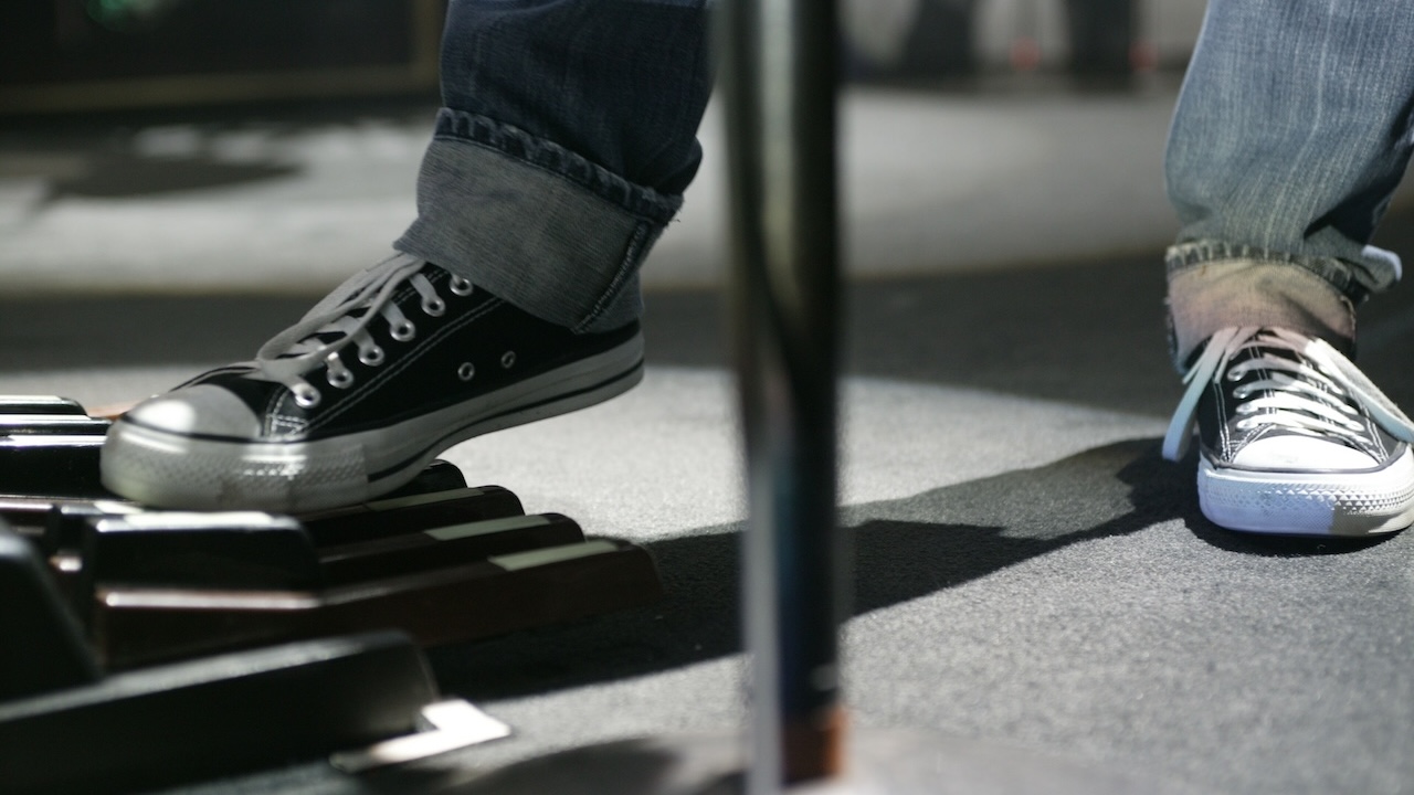 Rush; music group, rock music; Canada singer and bassist Geddy Lee plays the keyboard with his feet during a performance in the Alsterdorfer Sporthalle Hamburg