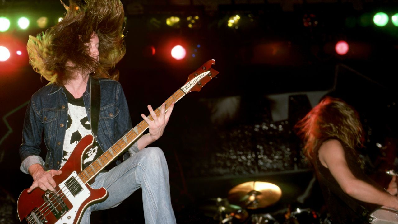 American songwriter and former bass player member with Metallica, Cliff Burton (1962-1986), and American songwriter, guitarist, lead vocalist and founding member of Metallica James Hetfield perform at the Royal Oak Music Theatre in Royal Oak, MI on February 1, 1985.