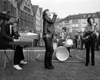 (from left) Ray Manzarek, Jim Morrison, John Densmore, and Robby Krieger perform on the street in Frankfurt, Germany on September 14, 1968