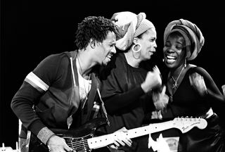 Junior Marvin, Marcia Griffiths and Rita Marley performing on stage