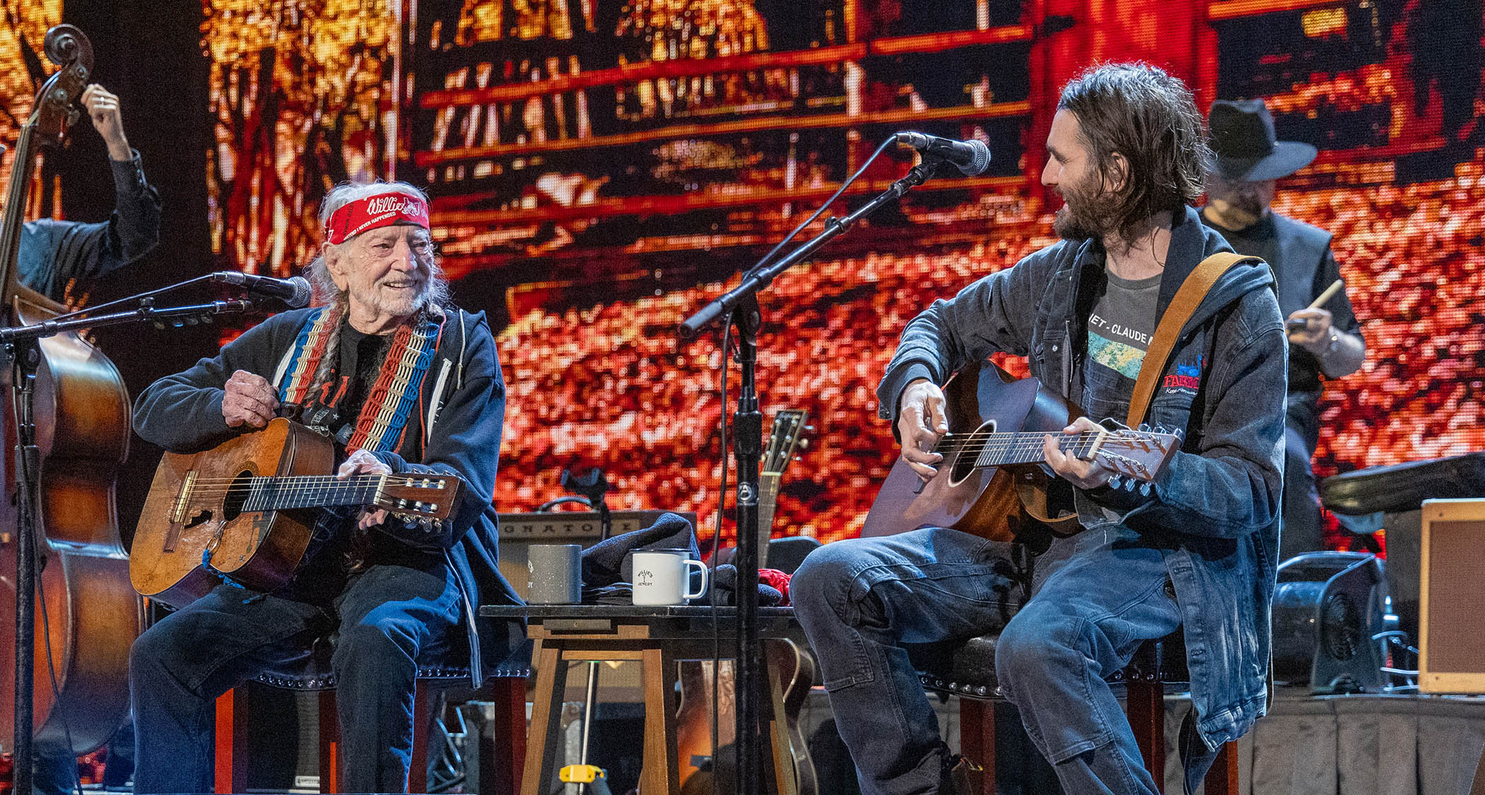 Willie Nelson and Micah Nelson: father and son perform on acoustics together at Farm Aid 2024. Nelson senior wears a red bandana.