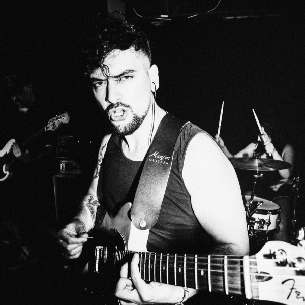 Guitar World author Matt McCracken playing guitar on stage