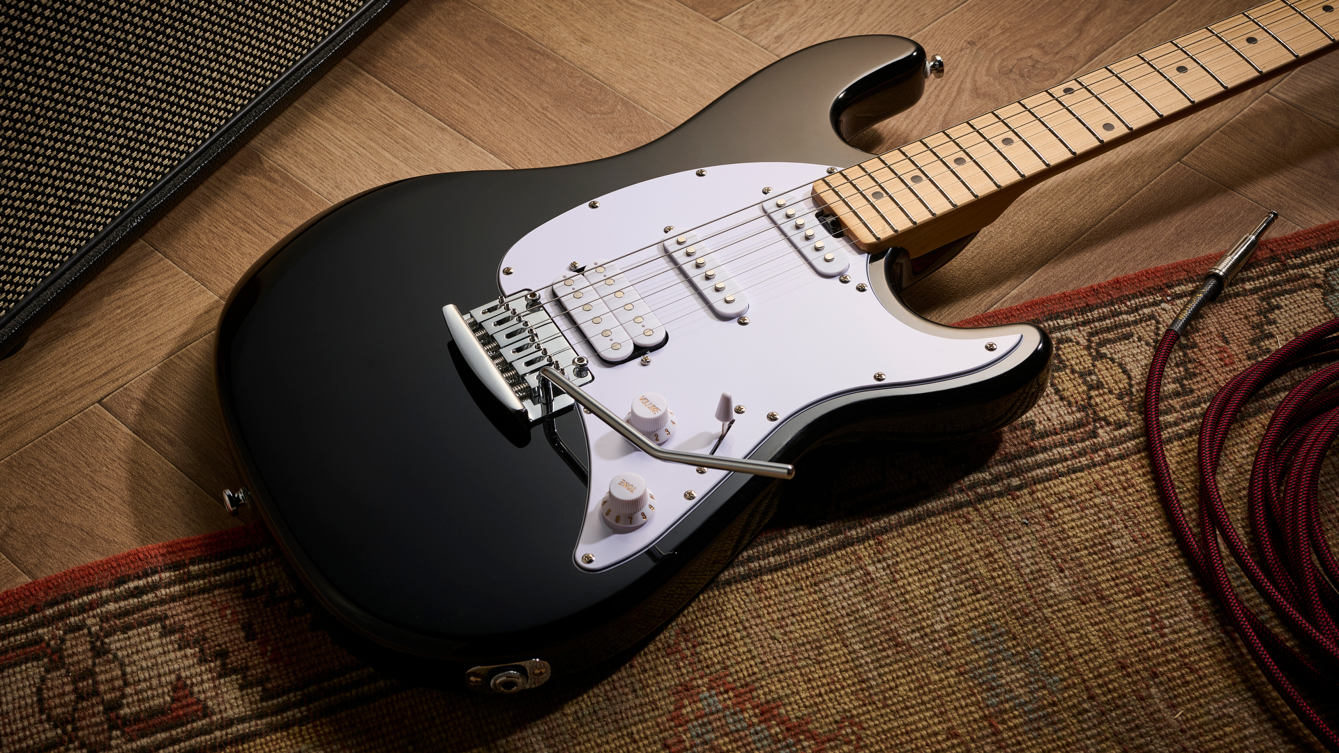 Sterling By Music Man Intro Series Cutlass: the entry-level double-cut electric is finished in gloss black, has a three-ply white pickguard and a maple fingerboard with black dot inlays.