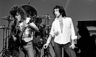 Angus Young (left) and Bon Scott, pictured onstage in Los Angeles, California in 1977