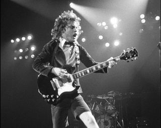 Angus Young performs onstage with AC/DC at the Hammersmith Odeon in London on November 1, 1979