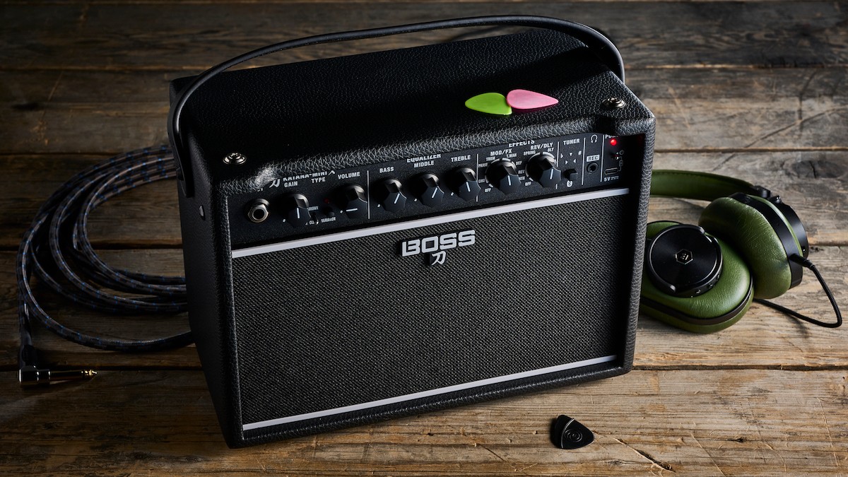 Boss Katana Mini X amp with a pair of green headphones plugged in