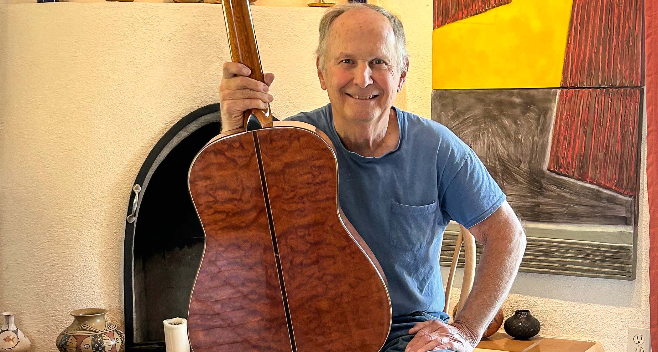 Don Musser, legendary custom luthier of acoustic guitars played by the likes of Bob Dylan and Tom Petty, poses with a heavily figured acoustic.