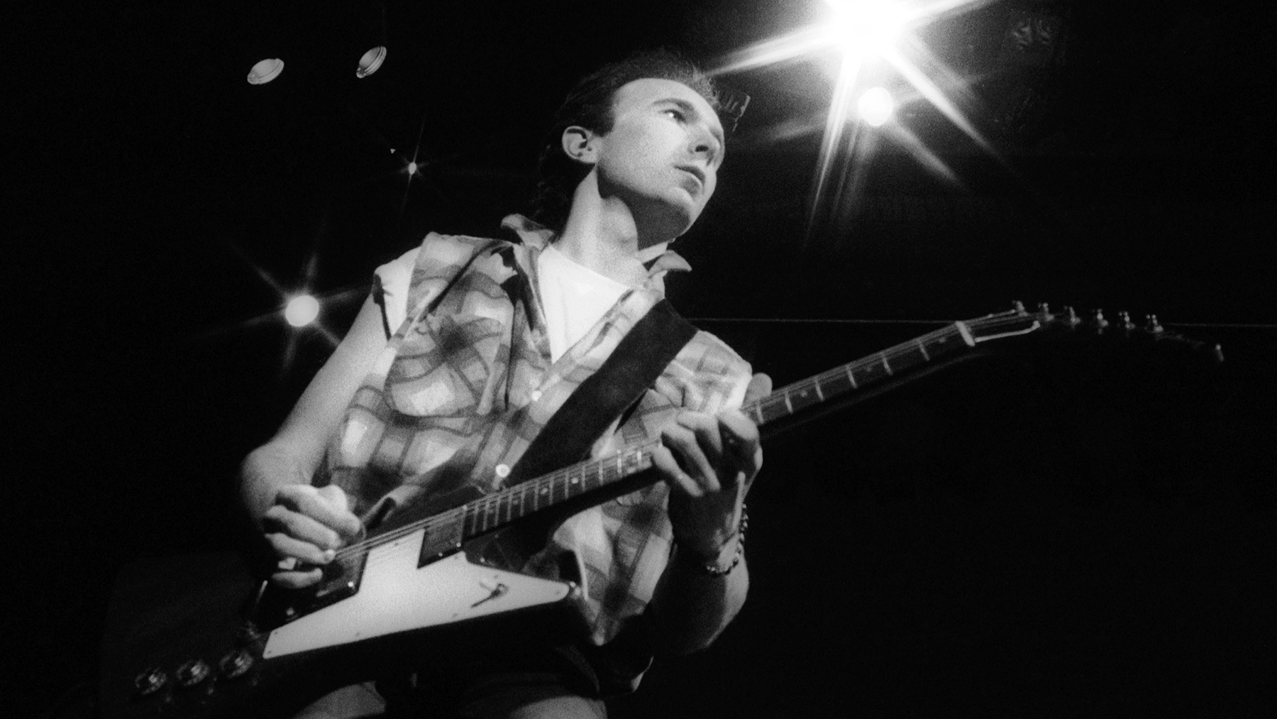 The Edge with the band 'U2' performing live on stage at the Sydney Entertainment Centre during their 'Unforgettable Fire' world concert tour in September, 1984 in Sydney, Australia.