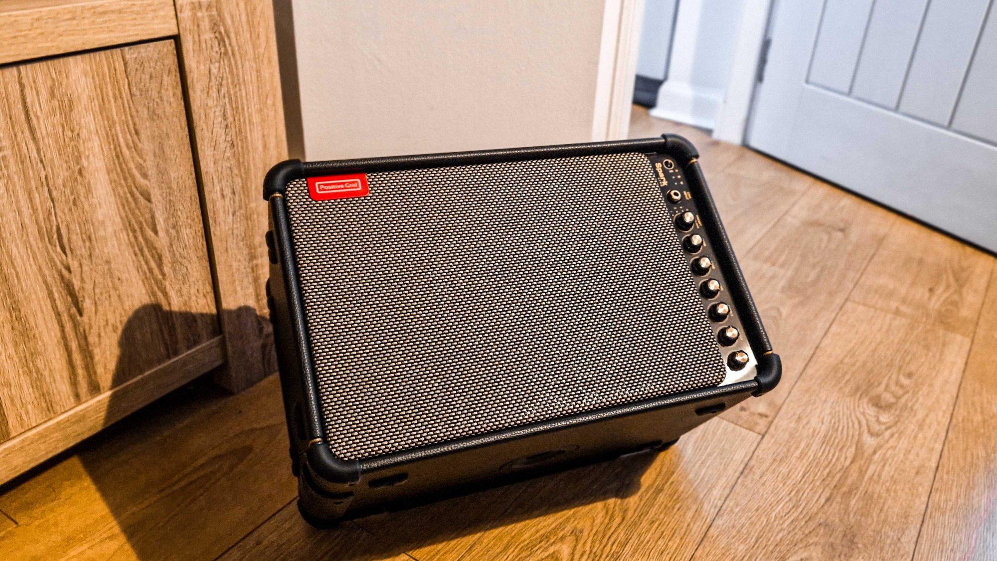 A Positive Grid Spark Live on a wooden floor