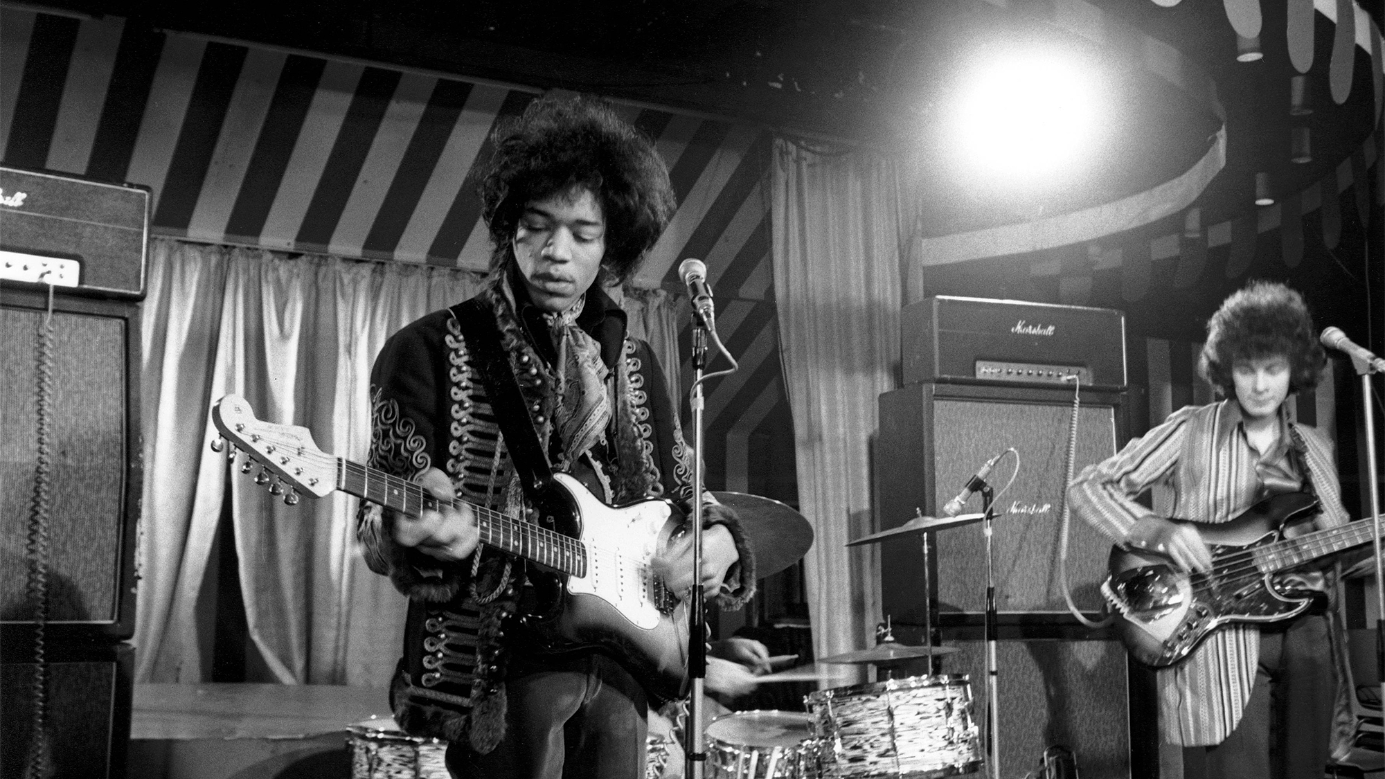 Jimi Hendrix Experience - L-R: Jimi Hendrix, Noel Redding - performing live onstage at the London Marquee while filming for the German TV Show 'Beat Club', with Marshall amplifiers behind, March 2, 1967. The group performed “Hey Joe” and “Purple Haze.
