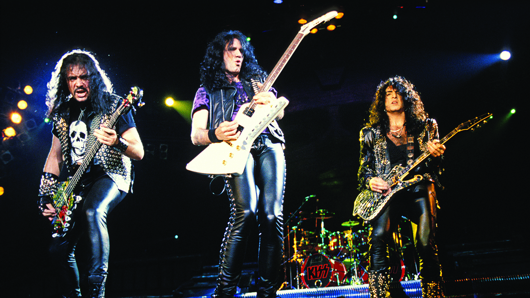 Kiss members (from left) Gene Simmons, Bruce Kulick and Paul Stanley perform live onstage, without make up, May 21, 1992