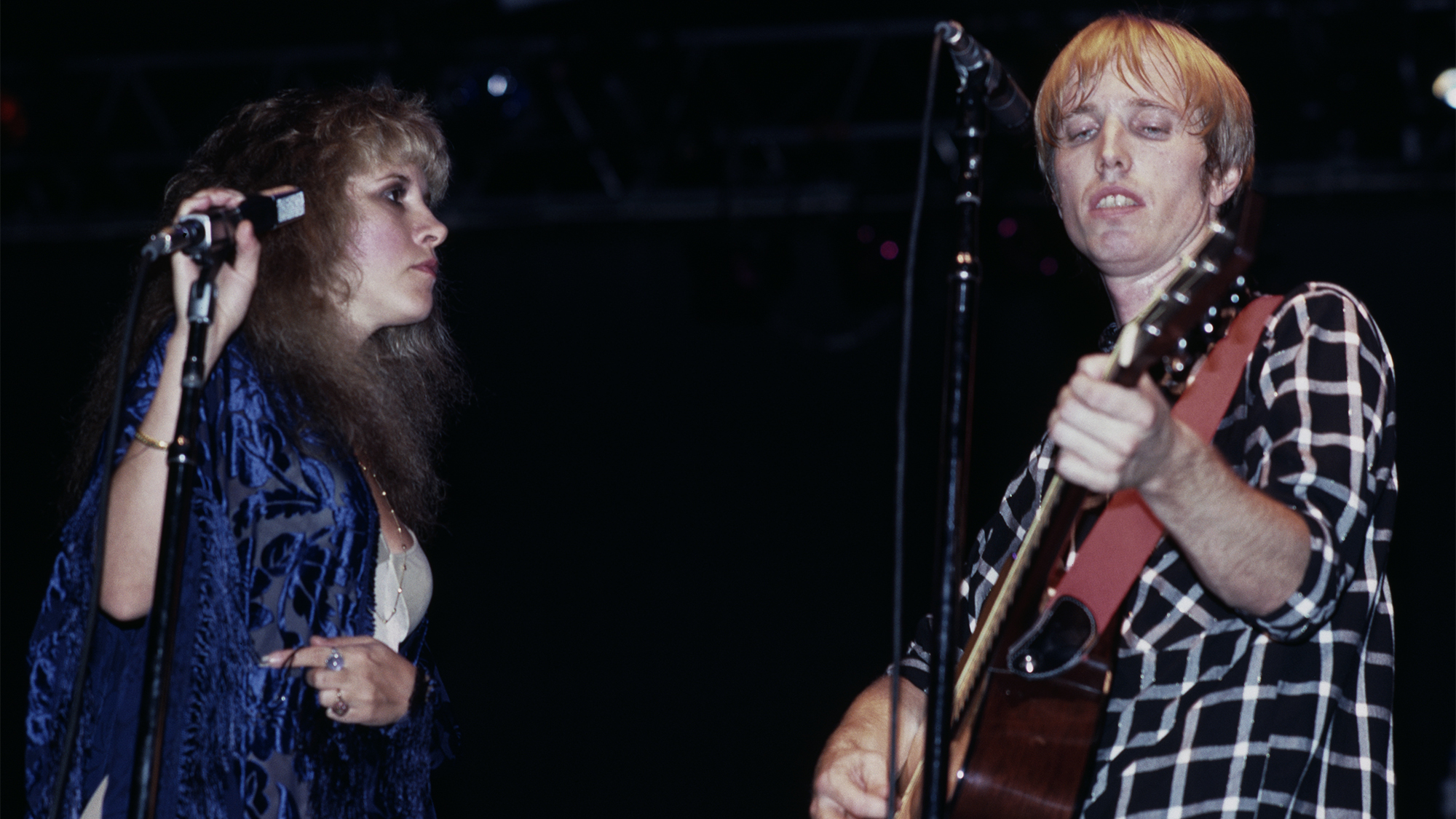 American singer-songwriter Stevie Nicks joins American singer-songwriter and guitarist Tom Petty (1950-2017) onstage as his band, Tom Petty & The Heartbreakers, play the Meadowlands Arena in East Rutherford, New Jersey, 30th July 1981.