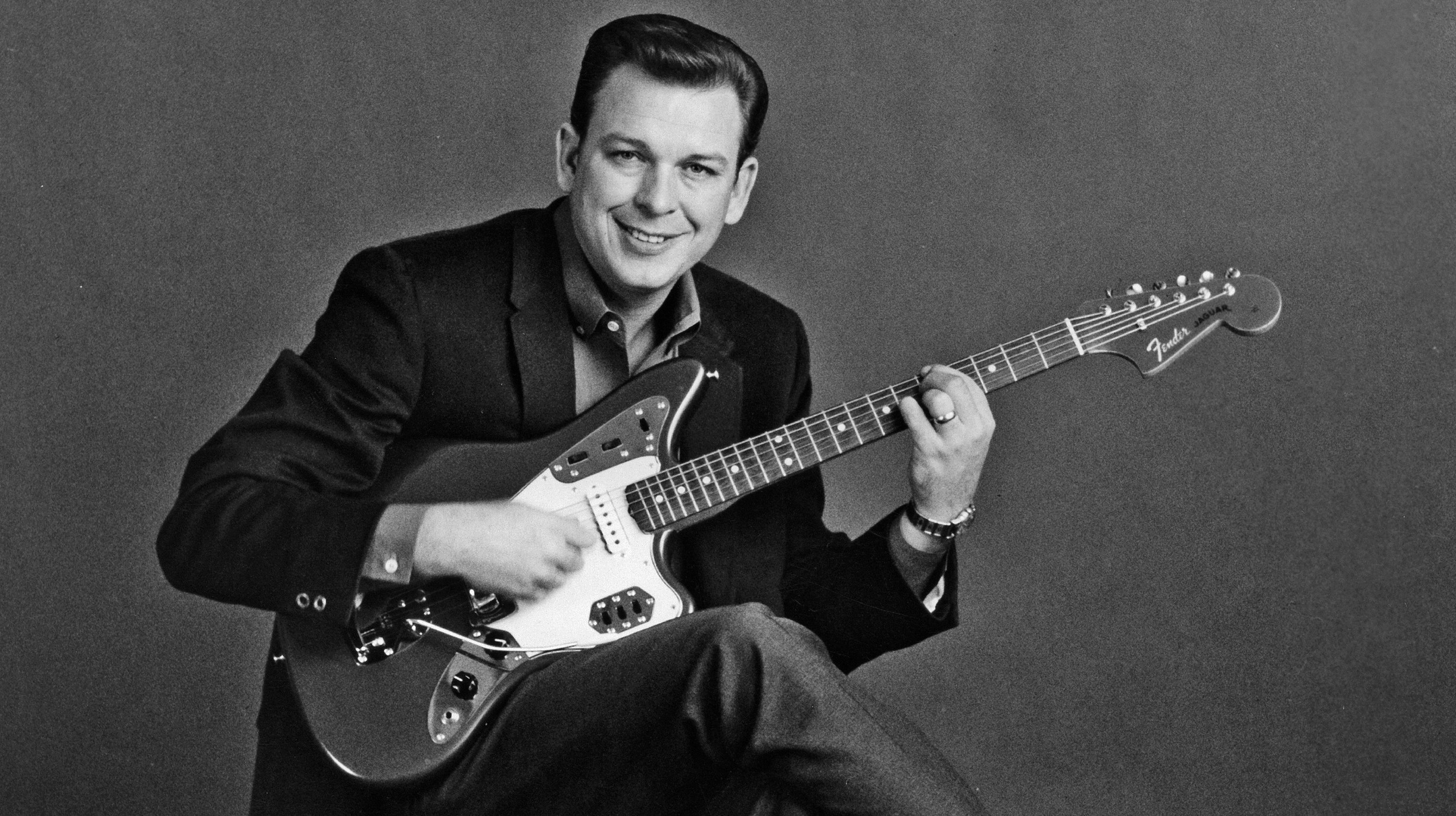 CIRCA 1960: Singer and songwriter Billy Strange poses for a portrait with a Fender electric guitar in circa 1960.