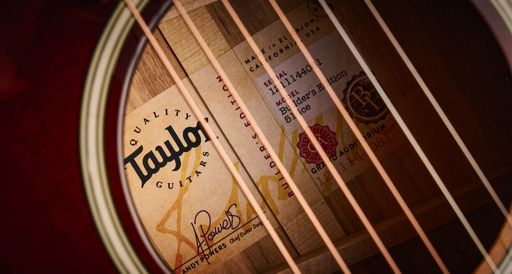 Taylor Builder&rsquo;s Edition 514ce Kona Burst pictured against a wooden floor and patterned rug.