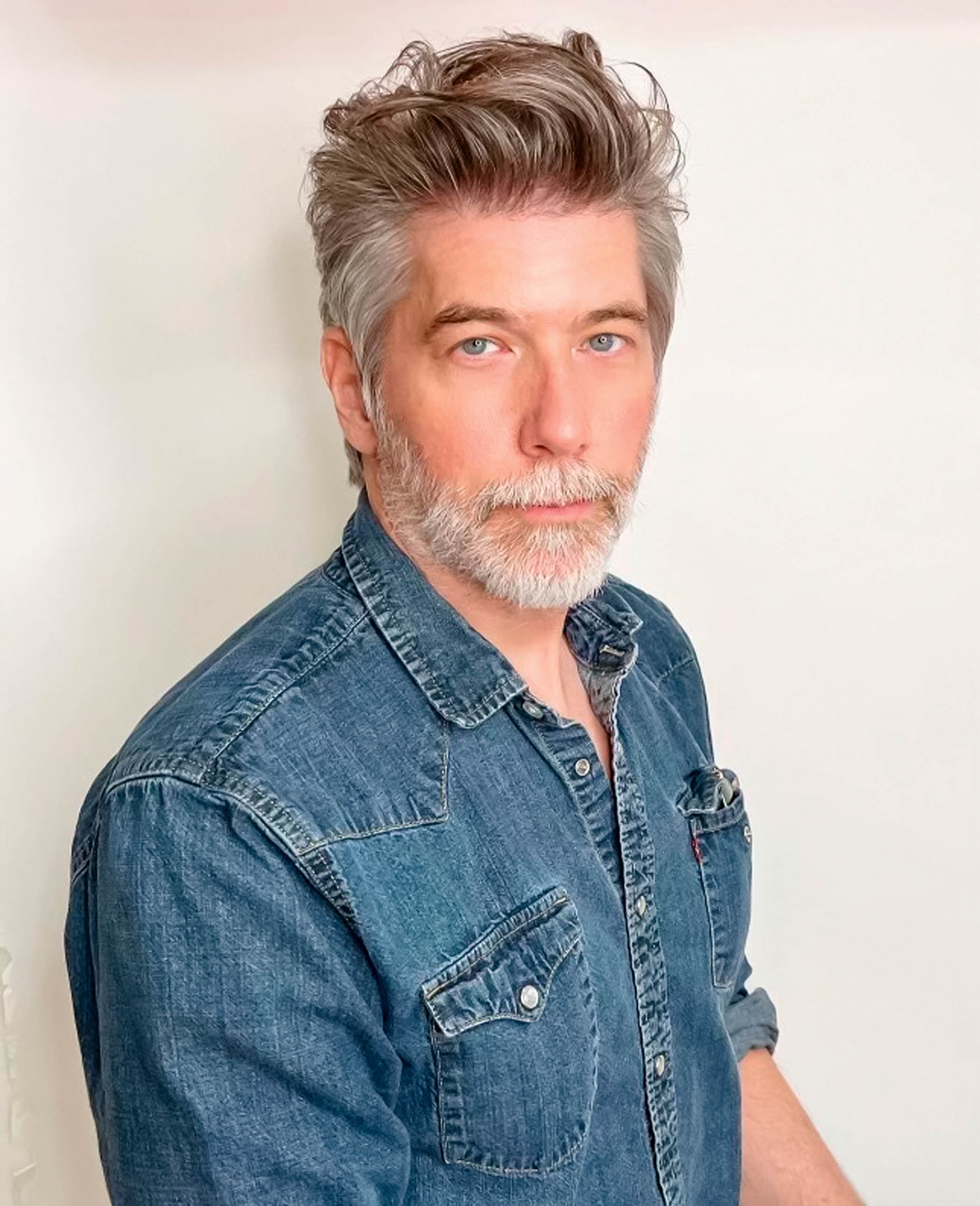 A portrait of Rick Heins, senior product manager, Fender, wearing a denim shirt.