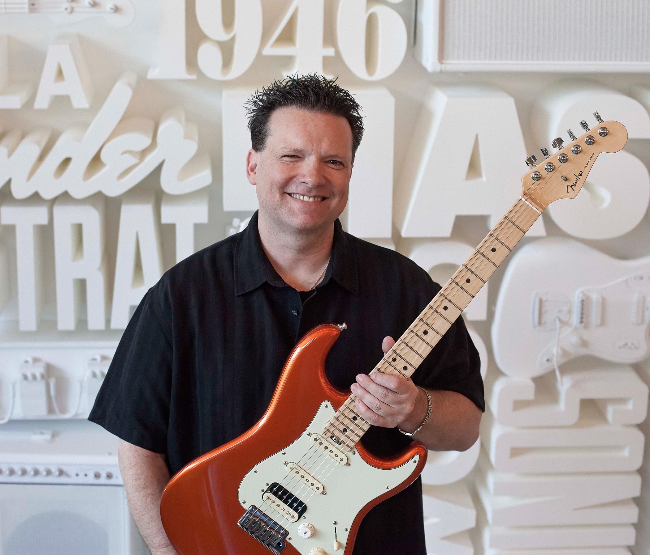 Fender's chief product officer Max Gutnik holds an HSS Stratocaster