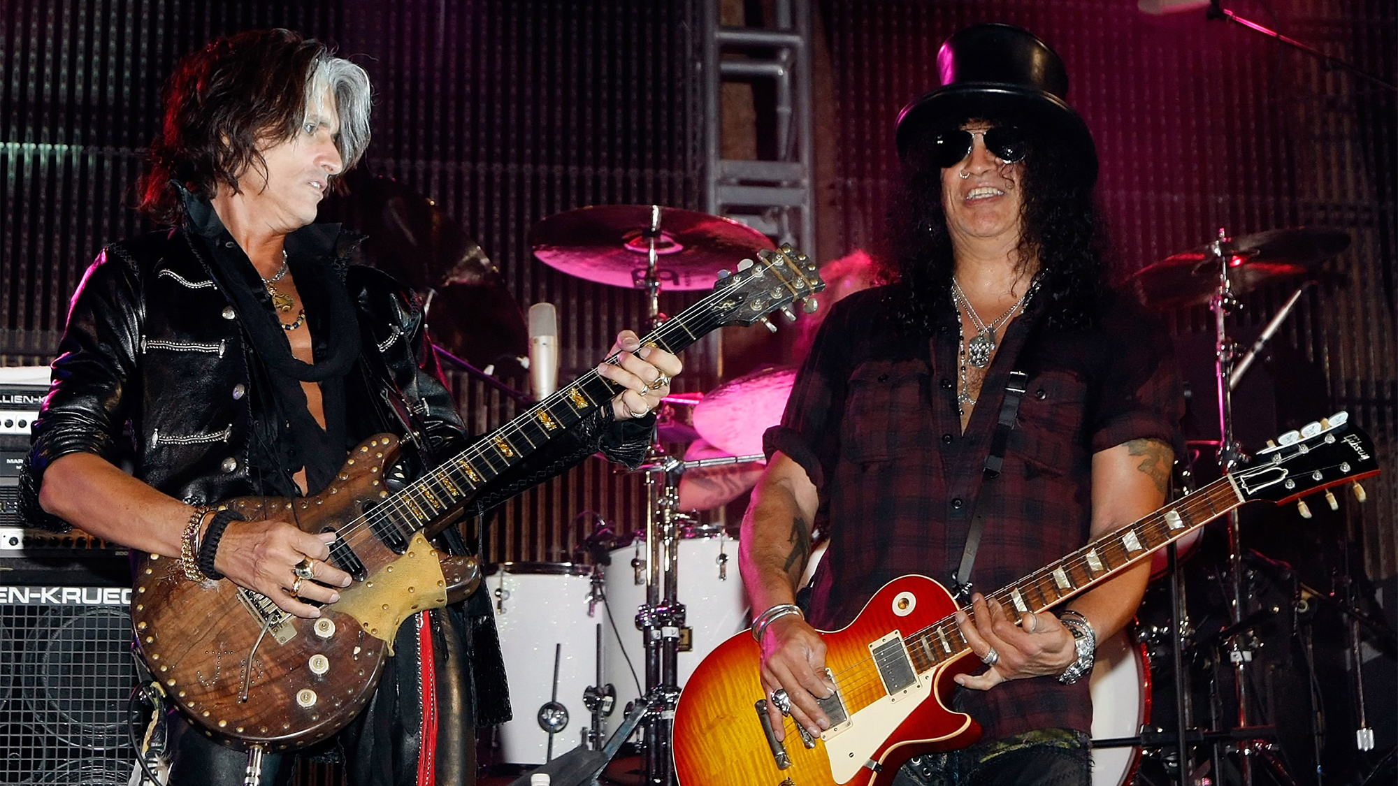 Aerosmith guitarist Joe Perry (L) and guitarist Slash perform during a concert at the Bare Pool Lounge at The Mirage Hotel &amp; Casino to celebrate the resort's 20th anniversary early on October 3, 2009 in Las Vegas, Nevada.