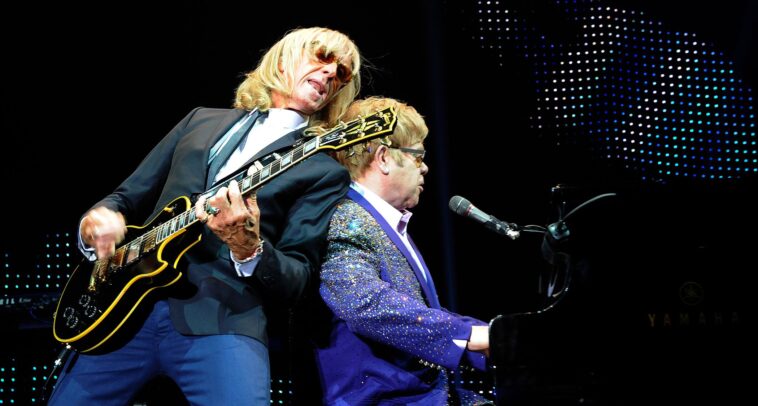 "Davey Johnstone Reflects on Guitar Shopping with Elton John: How He Landed His Iconic Les Paul Custom After a Memorable Moment at the Store"]