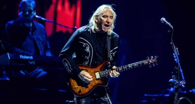 "Joe Walsh Reflects on His Best Guitar Solo and the Moment He Introduced the Talk Box: 'I pulled out some surgical tubing and told him, 'Put this in your mouth.' It smelled awful, but I went for it, and then I used it on Rocky Mountain Way.'"]