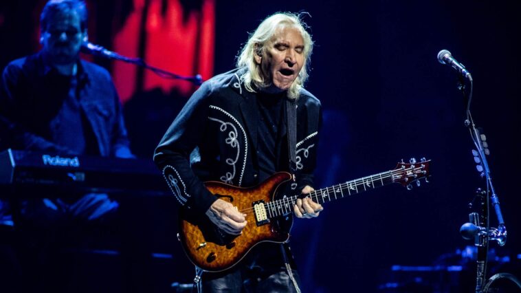 "Joe Walsh Reflects on His Best Guitar Solo and the Moment He Introduced the Talk Box: 'I pulled out some surgical tubing and told him, 'Put this in your mouth.' It smelled awful, but I went for it, and then I used it on Rocky Mountain Way.'"]