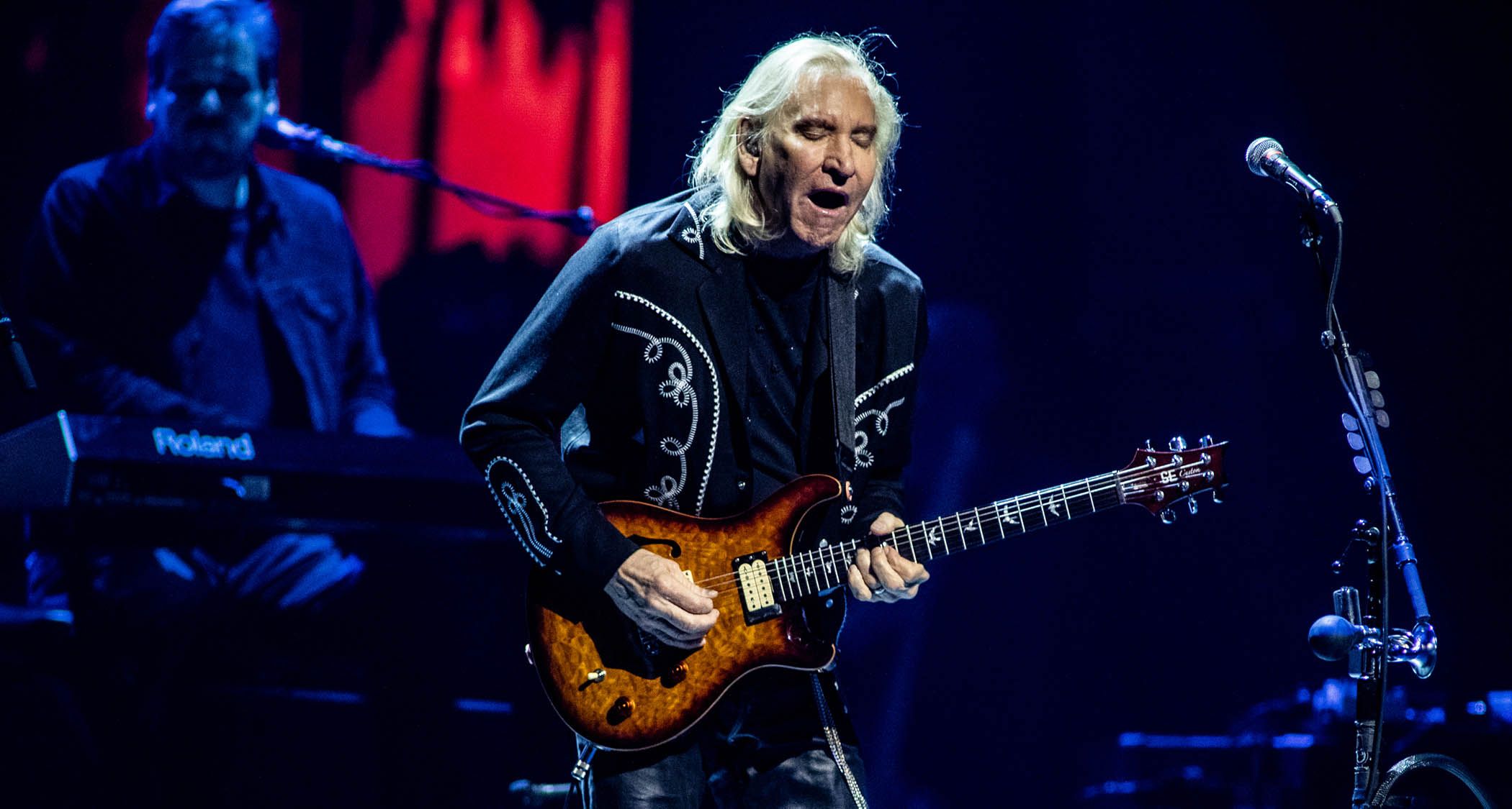 "Joe Walsh Reflects on His Best Guitar Solo and the Moment He Introduced the Talk Box: 'I pulled out some surgical tubing and told him, 'Put this in your mouth.' It smelled awful, but I went for it, and then I used it on Rocky Mountain Way.'"]