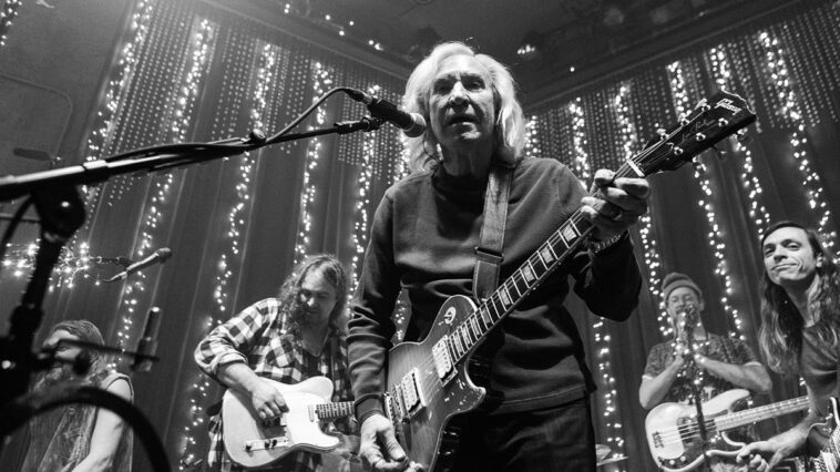 Joe Walsh collaborates with The War on Drugs for a benefit concert.]