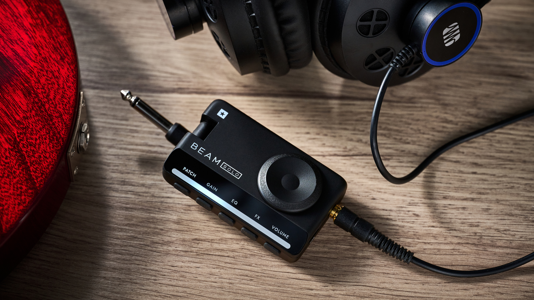 A Blackstar Beam Solo headphone amp for guitar lying on a wooden table