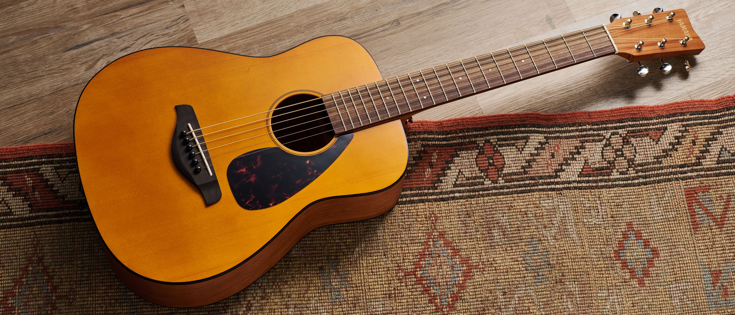 "Remove the craving for deep bass beats, and you'll discover plenty of enjoyment in the tones this Yamaha JR1 acoustic guitar can produce."]