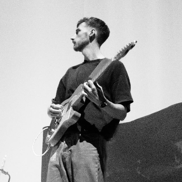 GuitarWorld.com News Editor Matt Owen playing guitar on stage