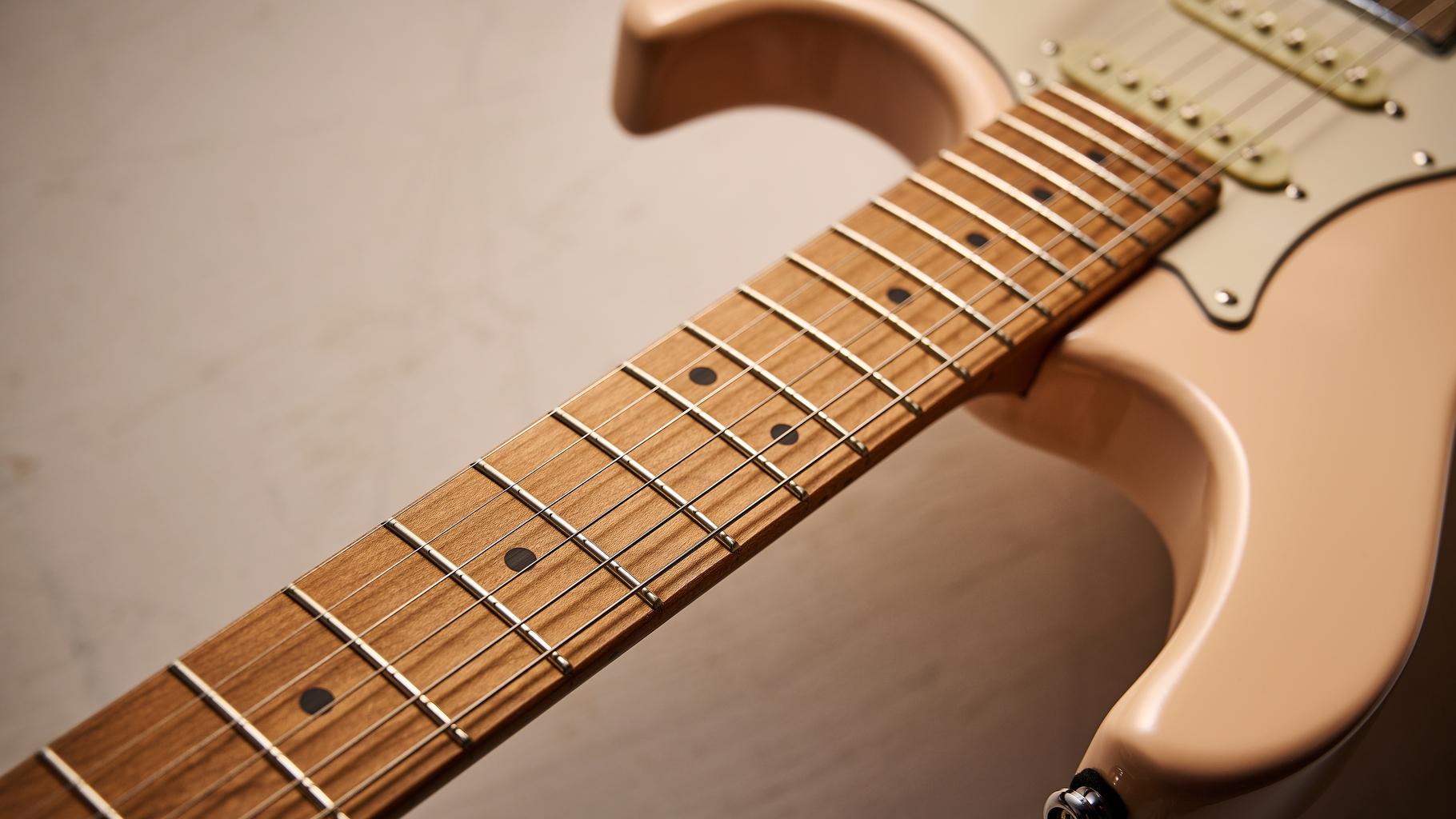 The roasted maple neck of a Cort G200SE electric guitar