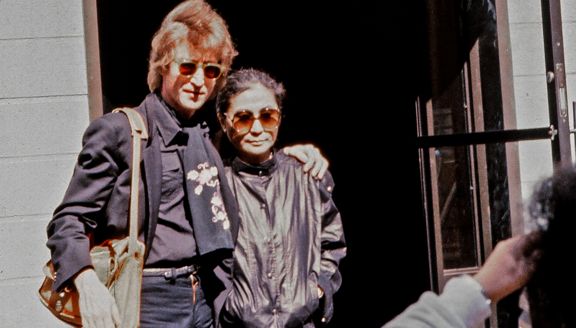 John Lennon and wife Yoko Ono pose for a photo outside the Hit factory recording studio, where they recorded Lennon and Ono's last album, Double Fantasy, on September 18, 1980 in New York City, New York.