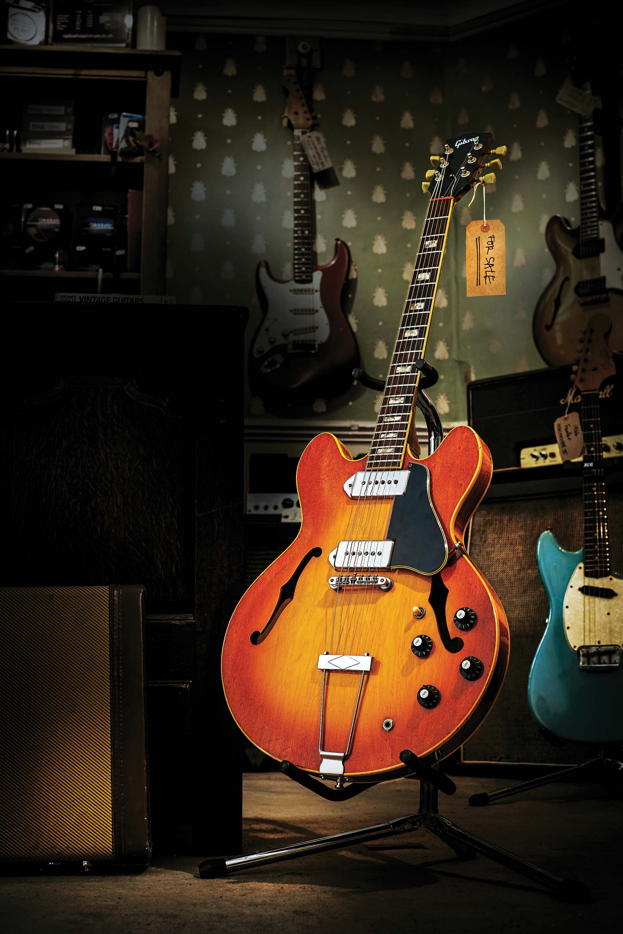 A Gibson ES-330 with its price tag on in an old-fashioned guitar store