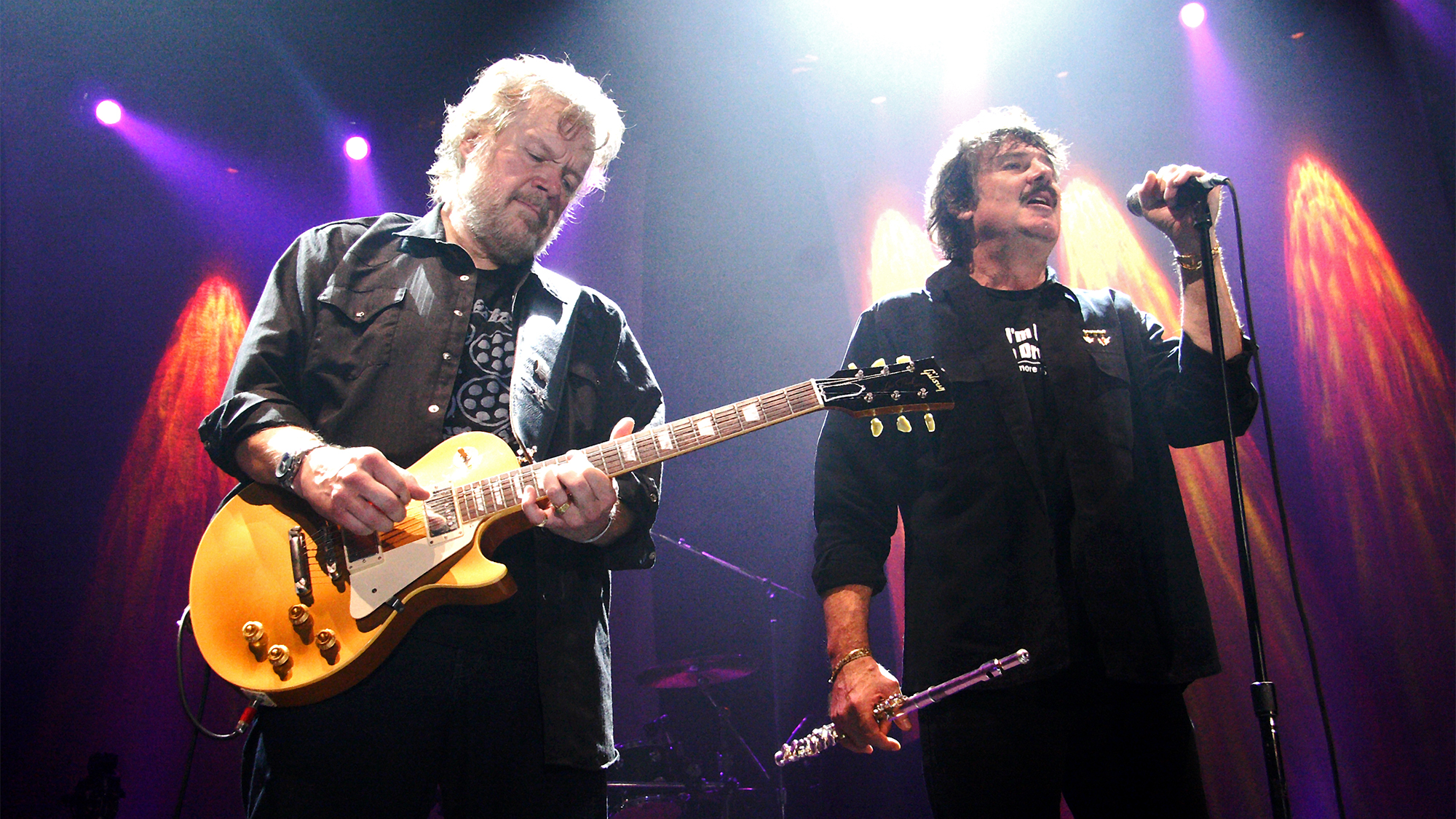 Randy Bachman (left) and Burton Cummings (right) perform onstage in 2024
