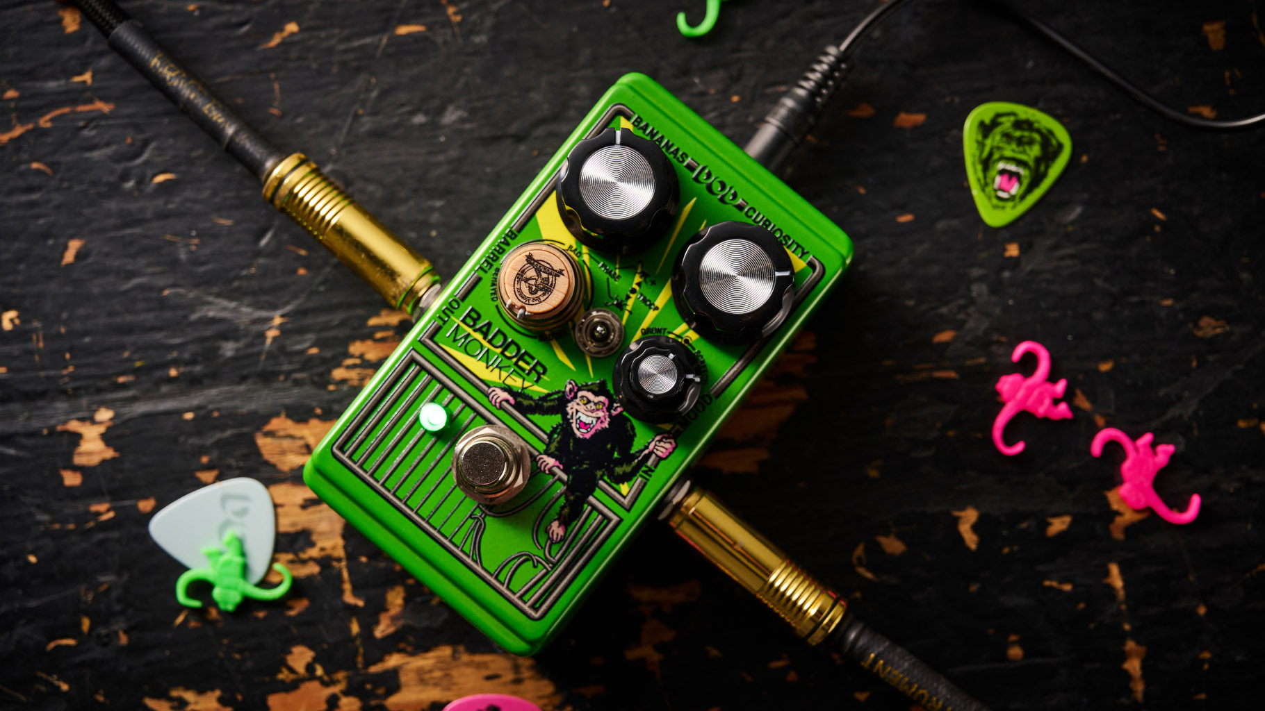 The DOD Badder Monkey is another little green overdrive pedal &ndash; but like no other. Pictured here against a distressed wooden floor, it has a wooden barrel control, and a primate illustration on the front.