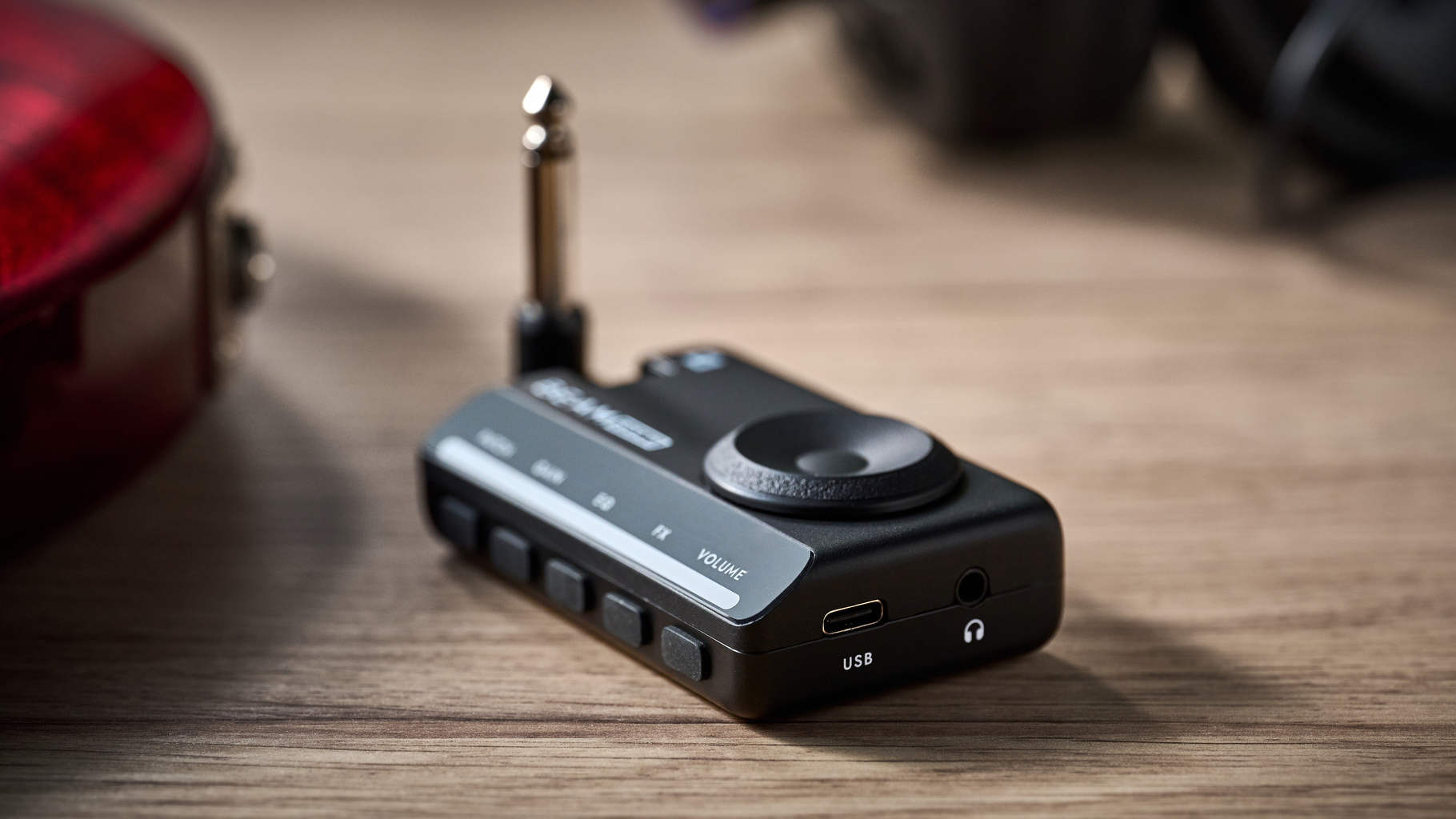 A Blackstar Beam Solo guitar headphone amp on a wooden table