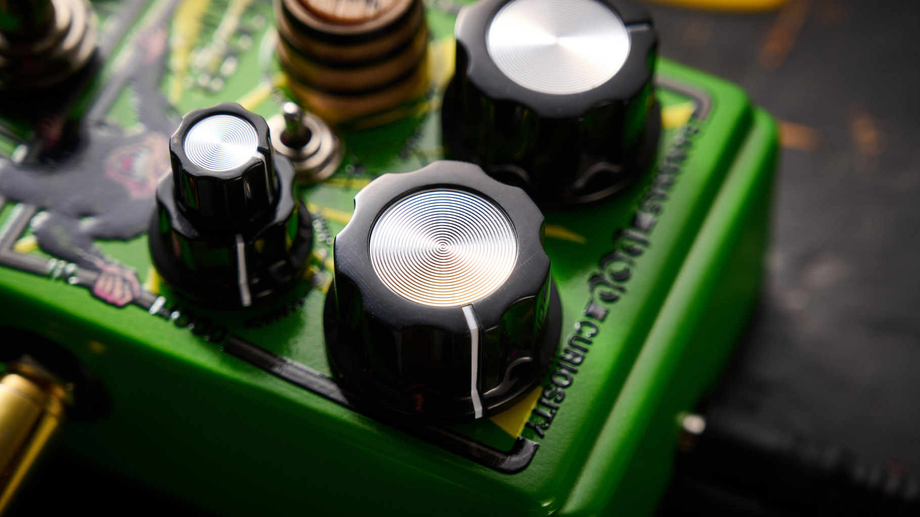 The DOD Badder Monkey is another little green overdrive pedal &ndash; but like no other. Pictured here against a distressed wooden floor, it has a wooden barrel control, and a primate illustration on the front.