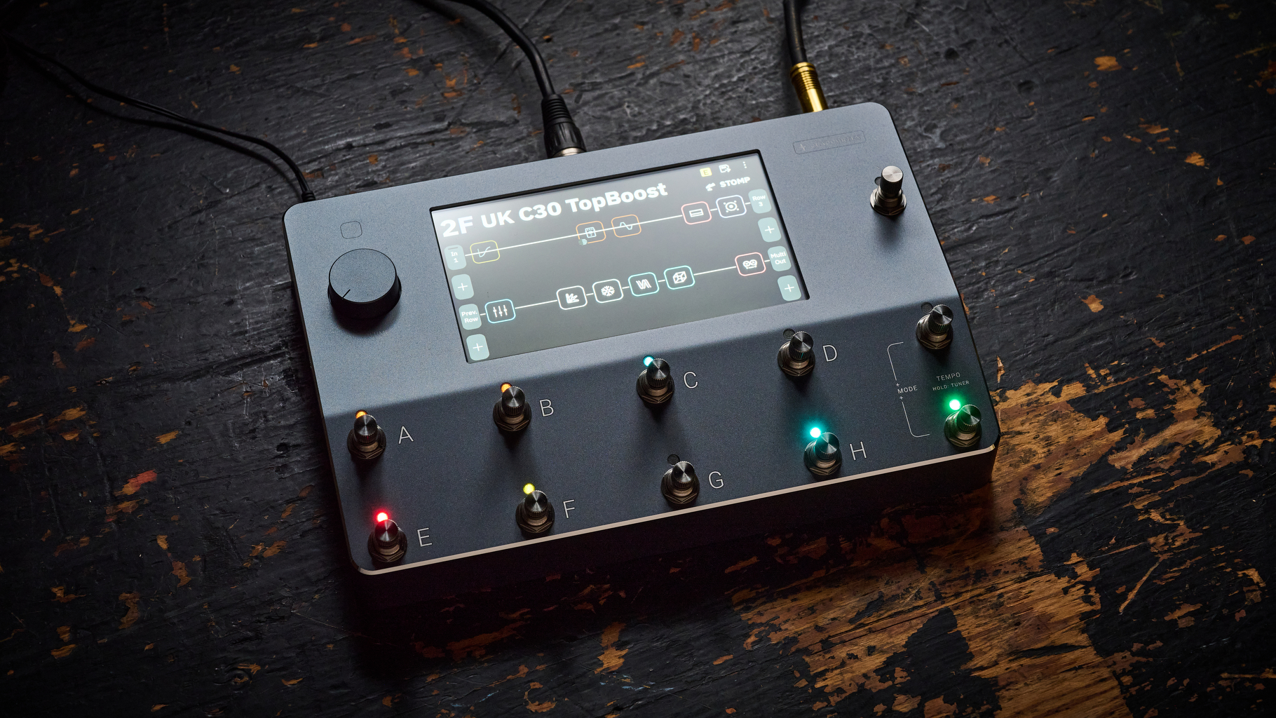 A Neural DSP Quad Cortex on a scratched wooden floor