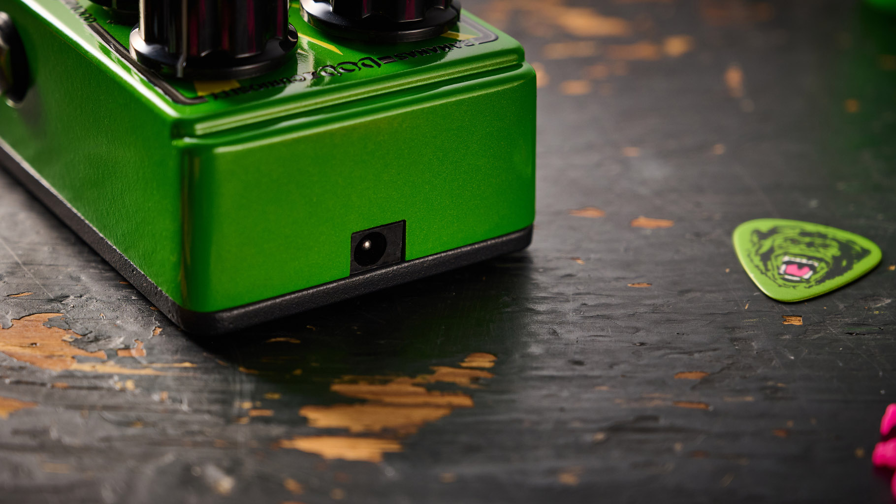The DOD Badder Monkey is another little green overdrive pedal &ndash; but like no other. Pictured here against a distressed wooden floor, it has a wooden barrel control, and a primate illustration on the front.