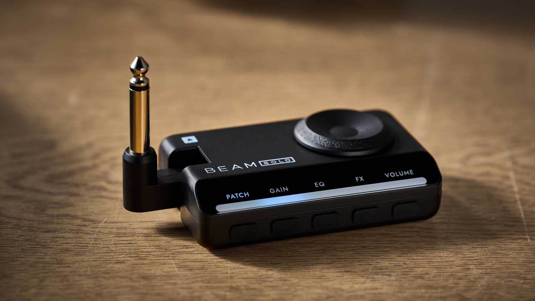 A Blackstar Beam Solo headphone amp for guitar lying on a wooden table