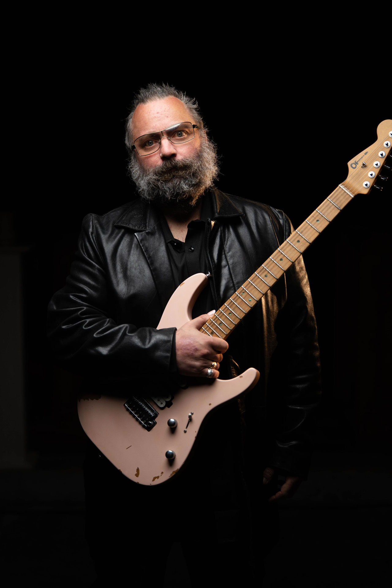 Rick Graham holds his Charvel Signature Pro-Mod DK24 2PT guitar, finished in Shell Pink