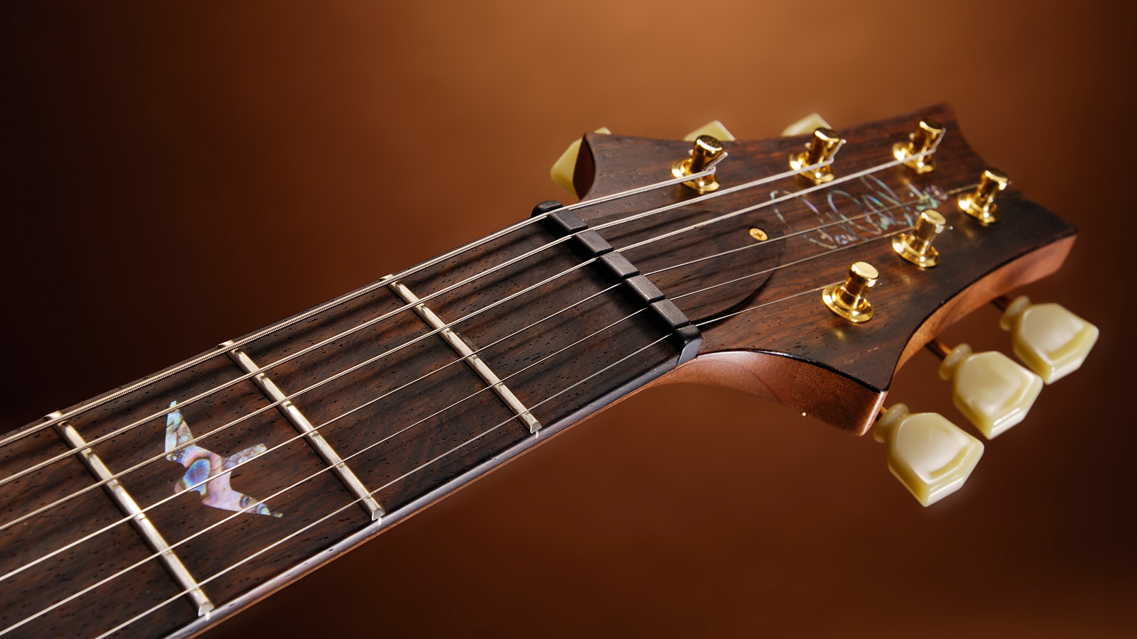 PRS headstock on orange background