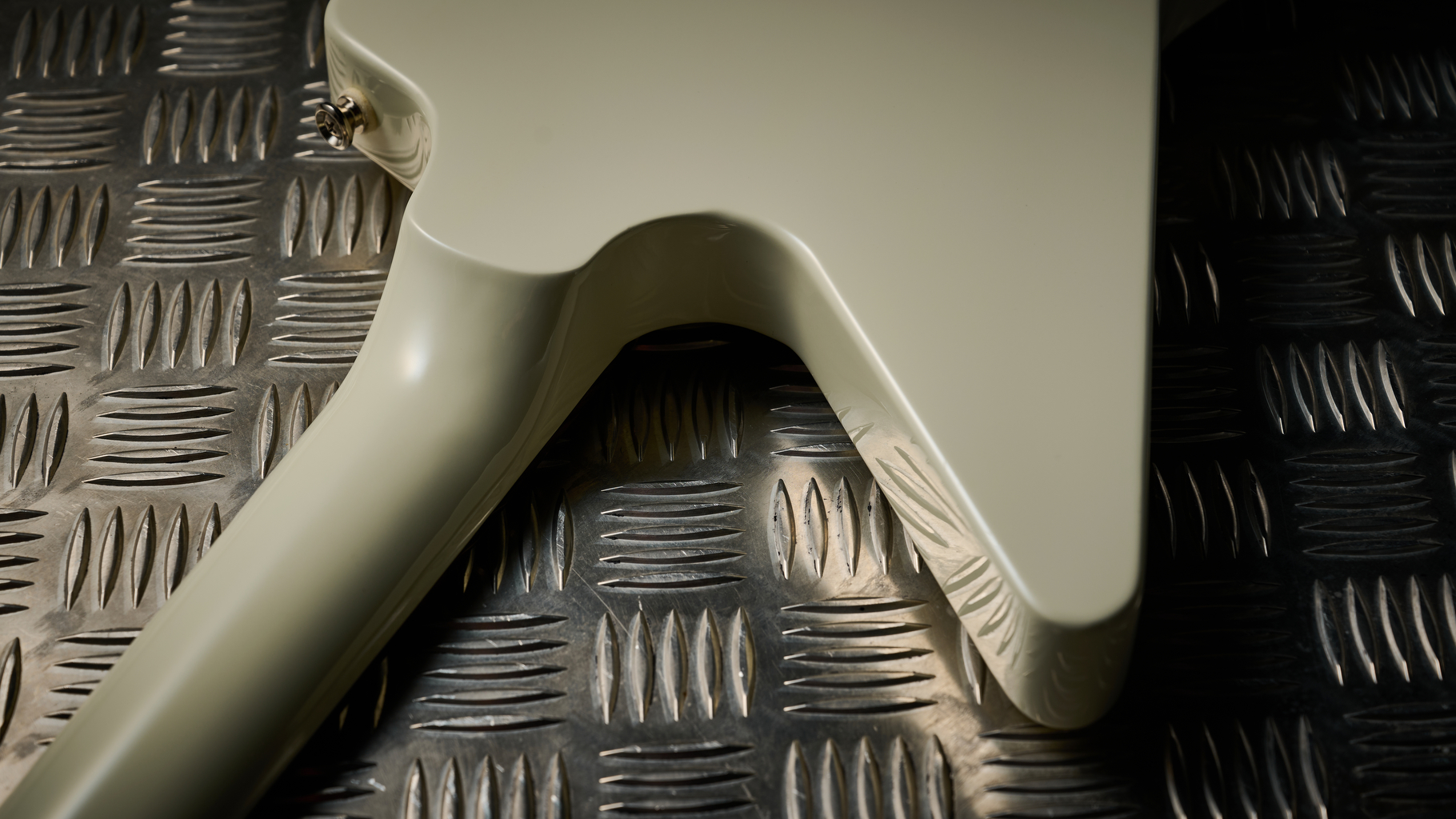 The set neck joint on an Epiphone Explorer 80s EMG electric guitar