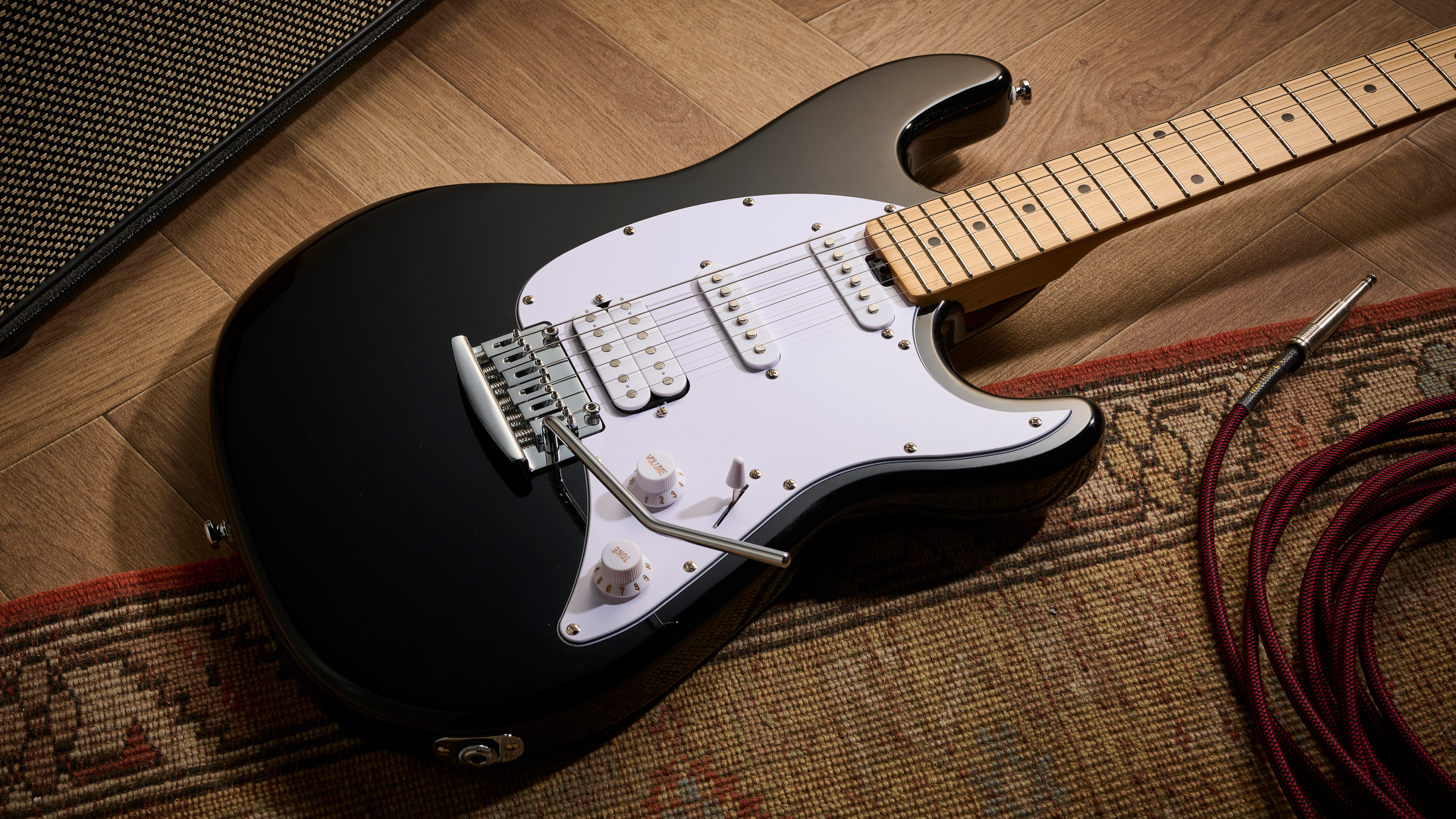 Sterling By Music Man Intro Series Cutlass: the entry-level double-cut electric is finished in gloss black, has a three-ply white pickguard and a maple fingerboard with black dot inlays.