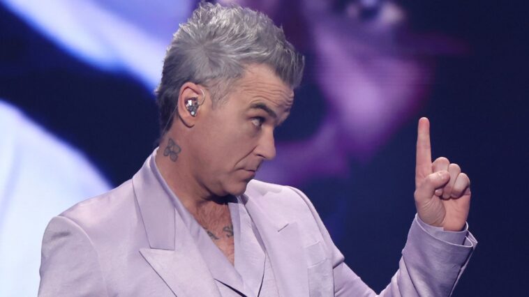 "Absolutely, that's my top priority in my career at the moment": Robbie Williams aims to surpass The Beatles' record of 15 UK Number One albums.]