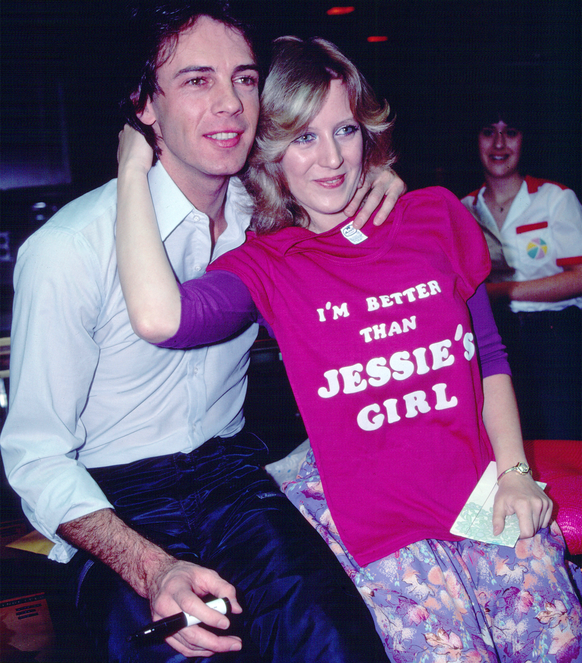 Australian-American Pop musician Rick Springfield poses with an unidentified fan during an instore appearance at the J&amp;R Music store, New York, New York, June 18, 1981. He was there to promote the release of his 'Working Class Dog' album; the fan poses with a t-shirt that reads 'I'm Better Than Jessie's Girl' (referencing a song on the album).