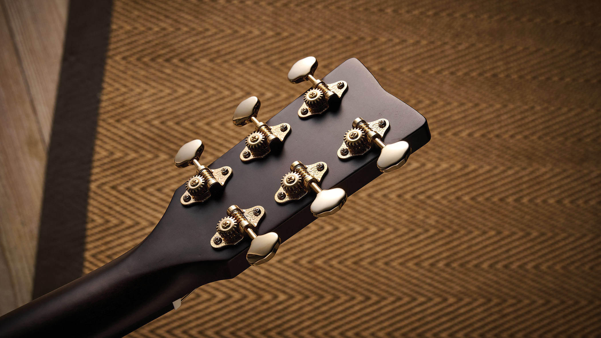The Yamaha TransAcoustic TAG3 C is a cutaway acoustic guitar with a sandburst finished, photographed in closeup