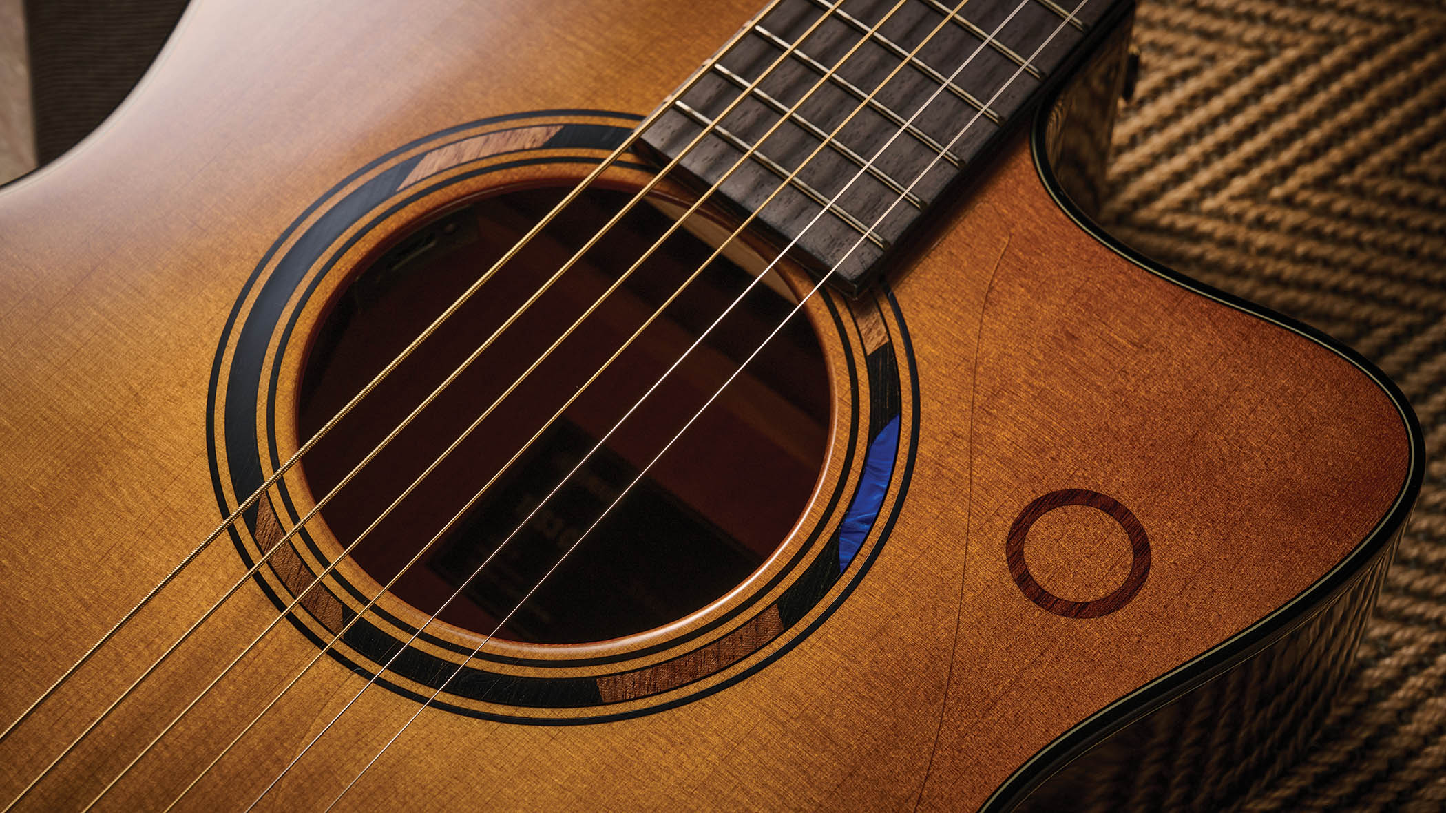 The Yamaha TransAcoustic TAG3 C is a cutaway acoustic guitar with a sandburst finished, photographed in closeup
