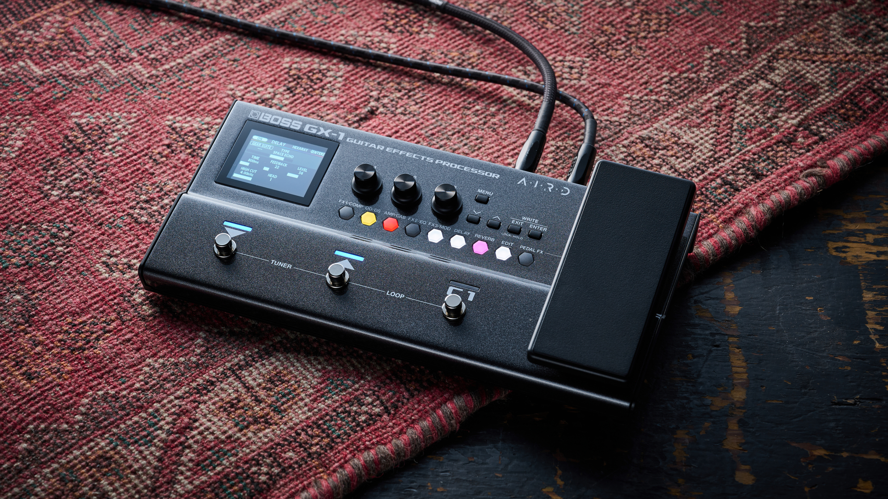 The Boss GX-1 multi-effects pedal lying on a worn rug