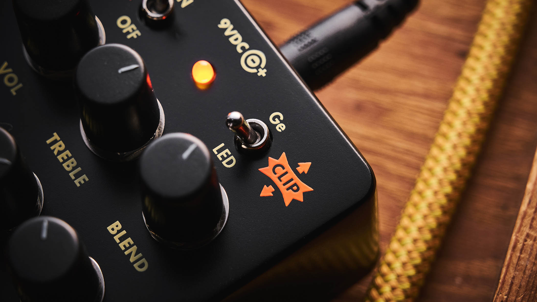 Electro-Harmonix Bender Royale &ndash; the feature-packed fuzz pedal is finished in a black enclosure with orange graphics/text, and is photographed here in warm tones against a wooden background.